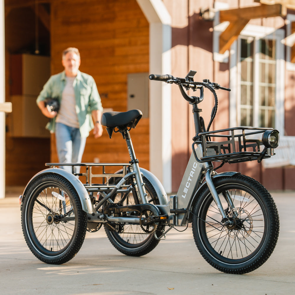 Man walking towards an Lectric XP Trike with cargo package