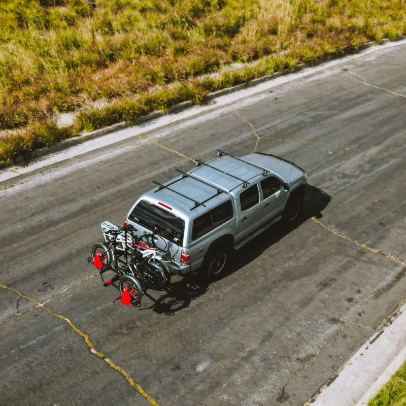 SUV driving on a road with a Lectric XP Trike on a bike rack