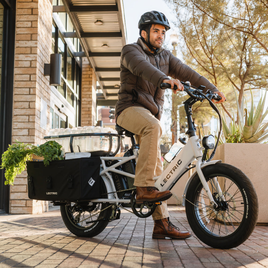 man riding lectric xpedition cargo ebike through city