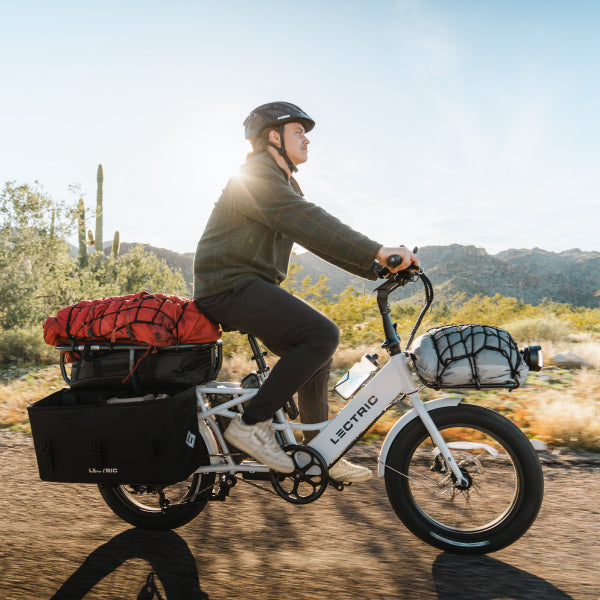 riding lectric ebike in desert with camping gear