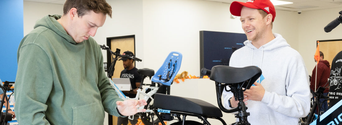 Two people learning about Lectric eBikes in the Showroom 