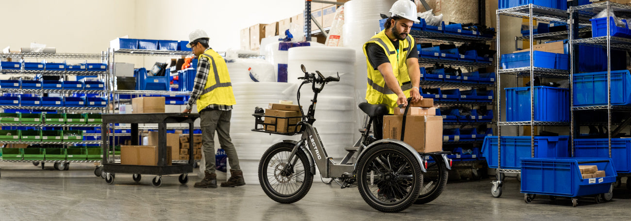 men in warehouse loading equipment on the XP Trike