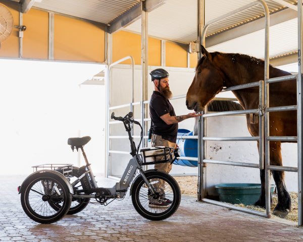 man using XP Trike to deliver carrots to a horse at Phoenix Zoo